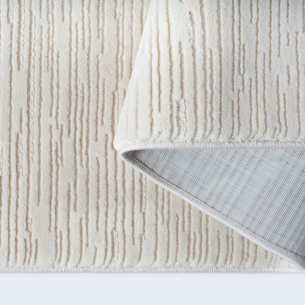 Nira 1962 – Teppich mit Linienmuster in Creme